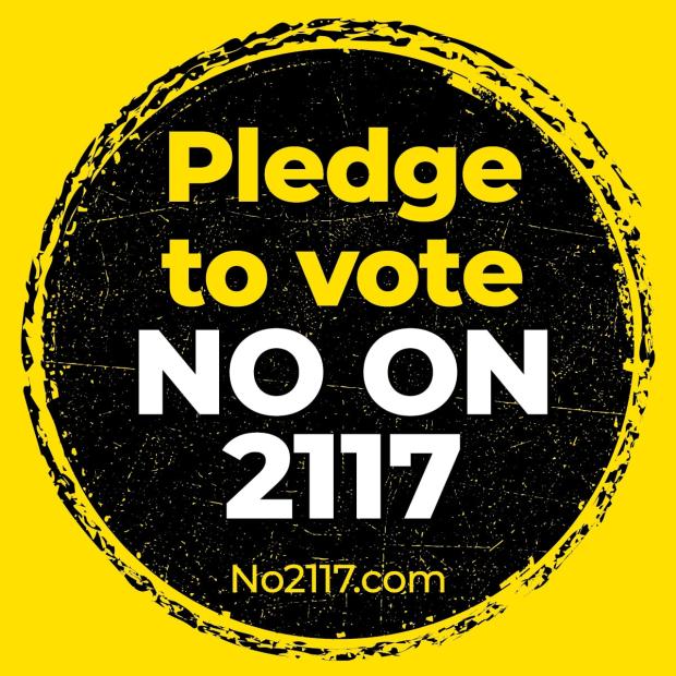 A yellow, white and black graphic that reads "Pledge to vote no on 2117." The URL "No2117.com" is at the bottom.