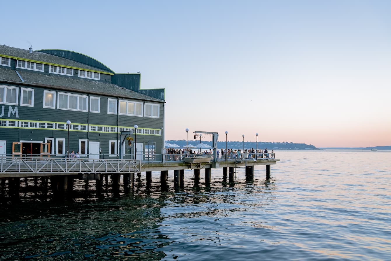 An exterior shot of the Seattle Aquarium and the Salish Sea at sunset.