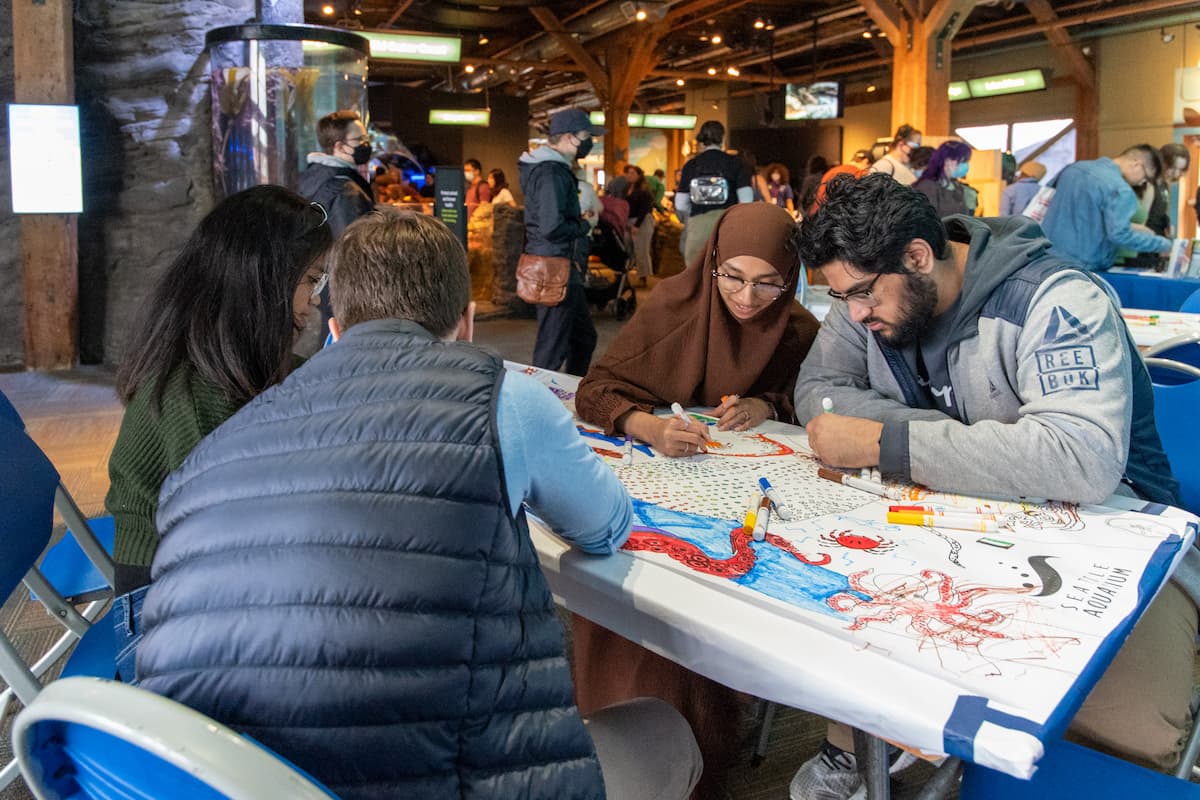 Four people coloring together at a table.