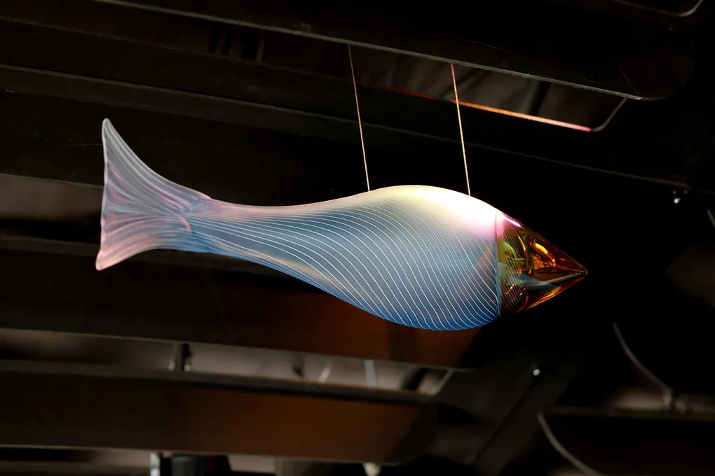 A blue glass salmon hanging from the ceiling of the Ocean Pavilion.