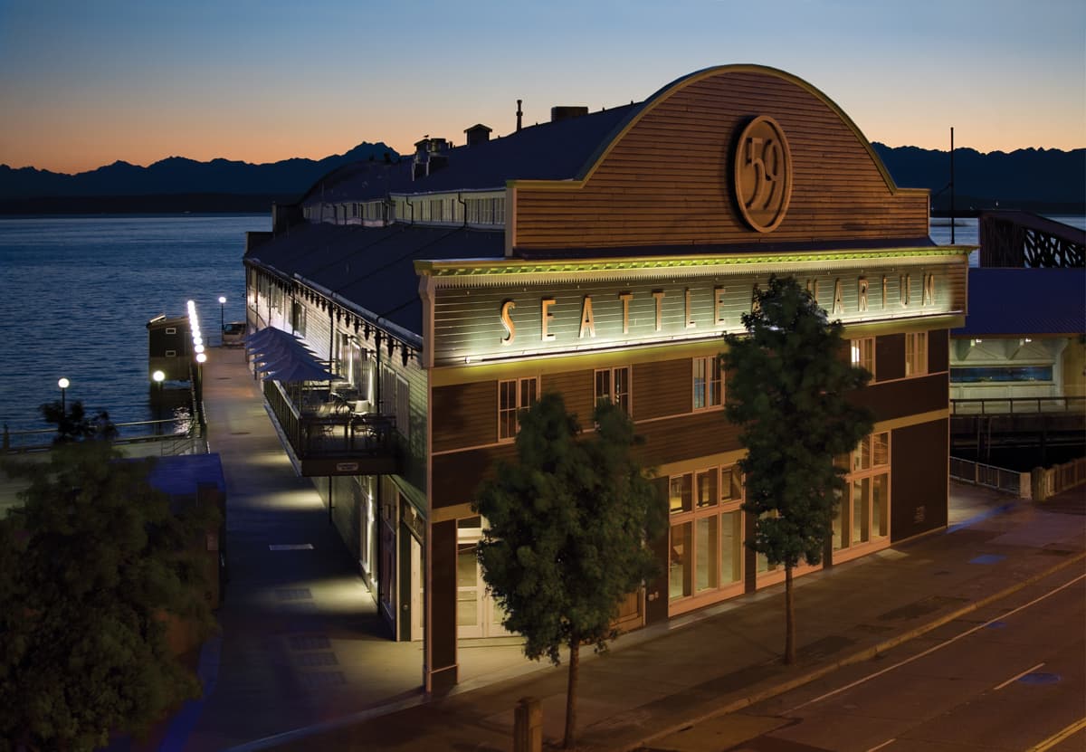 The exterior of the Seattle Aquarium's Pier 59 building at sunset.